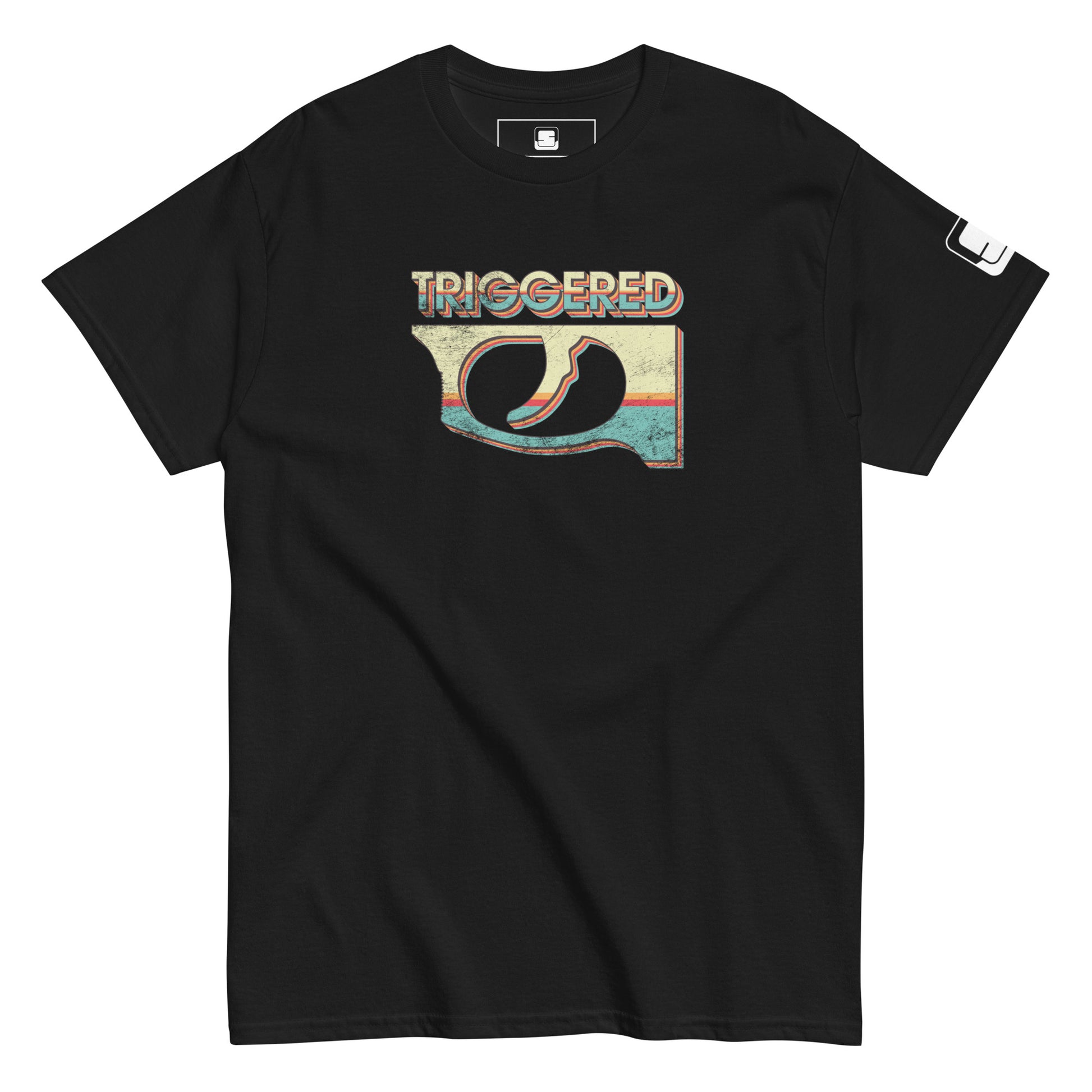 A close-up view of a black t-shirt featuring a vibrant, retro-inspired graphic. The design highlights a colorful gun trigger with the word 'TRIGGERED' across the top. 