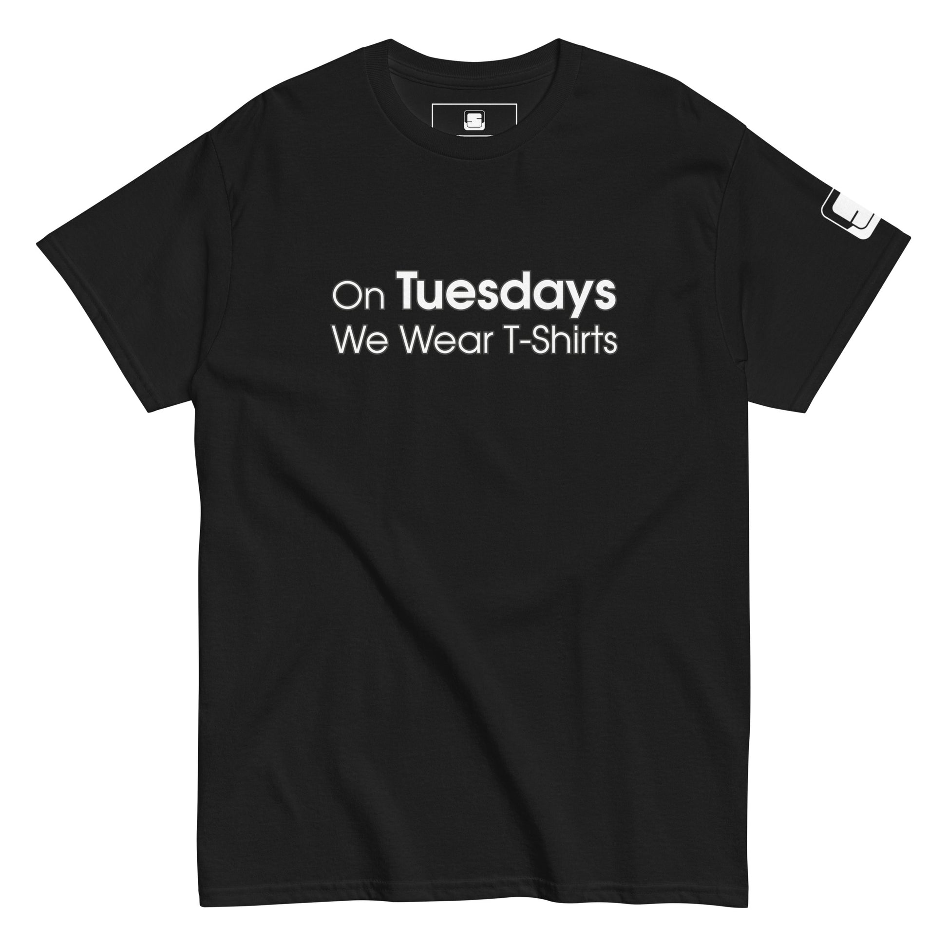 A black t-shirt displayed flat, featuring the phrase "On Tuesdays We Wear T-Shirts" in white uppercase letters across the chest. The shirt has a classic cut with a crew neck and short sleeves. A small logo patch is visible on the left sleeve, adding a subtle detail to the overall simple and modern design.