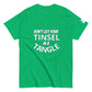 A vivid green t-shirt displayed flat, featuring the phrase "DON'T GET YOUR TINSEL IN A TANGLE" in large, bold teal letters. The text is prominently centered across the chest, offering a humorous and eye-catching design against the green background, ideal for festive occasions or casual wear.