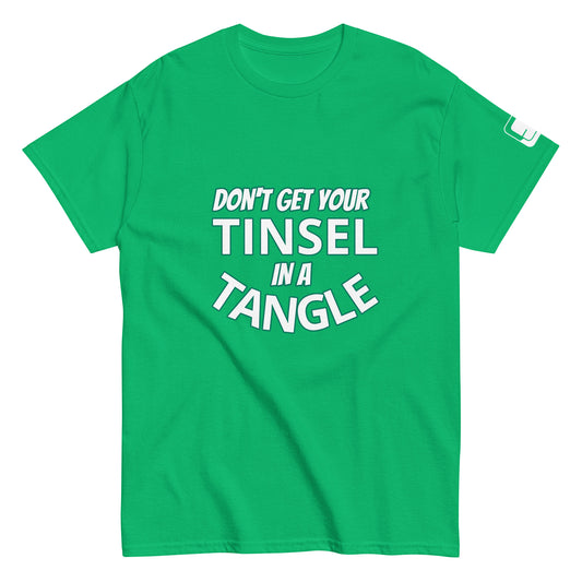 A vivid green t-shirt displayed flat, featuring the phrase "DON'T GET YOUR TINSEL IN A TANGLE" in large, bold teal letters. The text is prominently centered across the chest, offering a humorous and eye-catching design against the green background, ideal for festive occasions or casual wear.