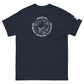 A simple yet bold navy t-shirt adorned with a white graphic playfully declaring "Houston...we have a tee shirt problem," encircling an astronaut and symbols of adventure in space including a planet, alian, and t-shirts, all arranged in a lighthearted, circular formation.