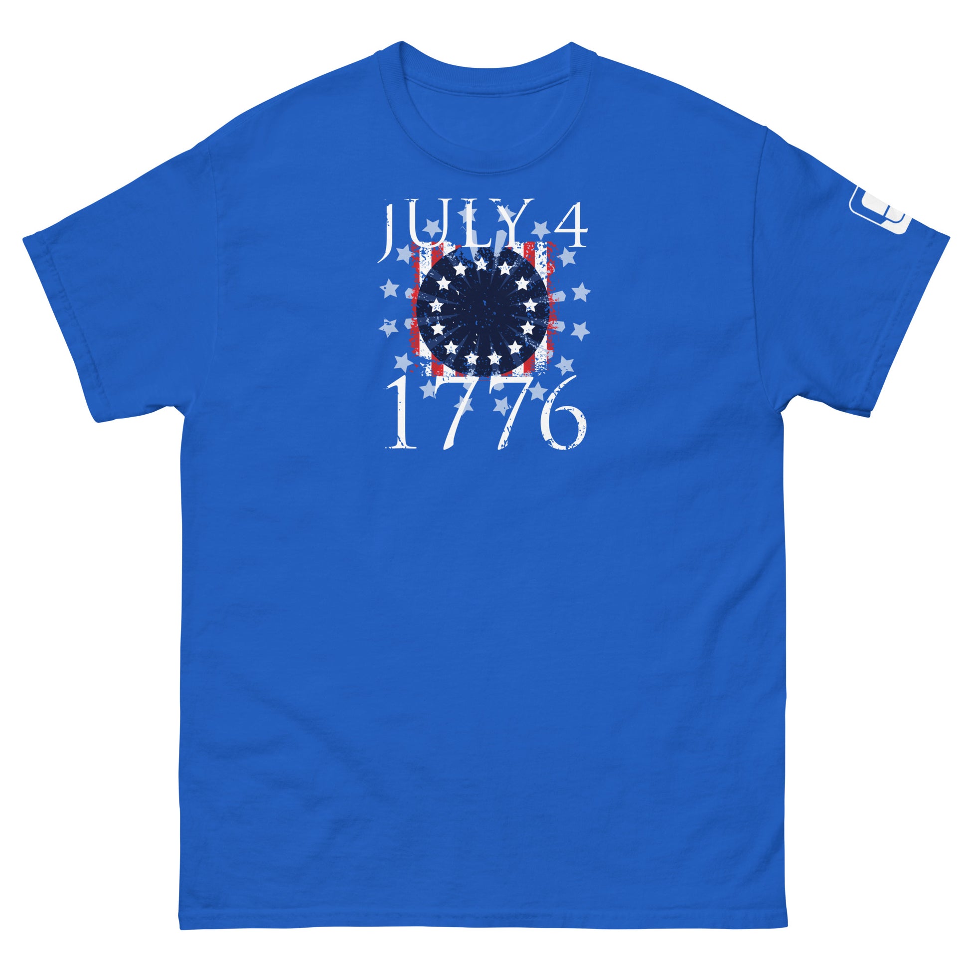 A royal blue t-shirt displayed flat, featuring a patriotic design. The design includes "July 4, 1776" in white, set against a flag motif with red and white stripes and a blue field of white stars arranged in a circular pattern to evoke a firework. The striking design symbolizes American heritage and is perfect for Fourth of July celebrations.