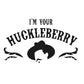 The image features a bold black and white design centered around the phrase 'I'm Your Huckleberry' in a curved, western-style font. Below the text, a stylized graphic includes a cowboy hat resting on a man's head, flanked by intricate filigree details on either side, enhancing the Old West theme of the design.