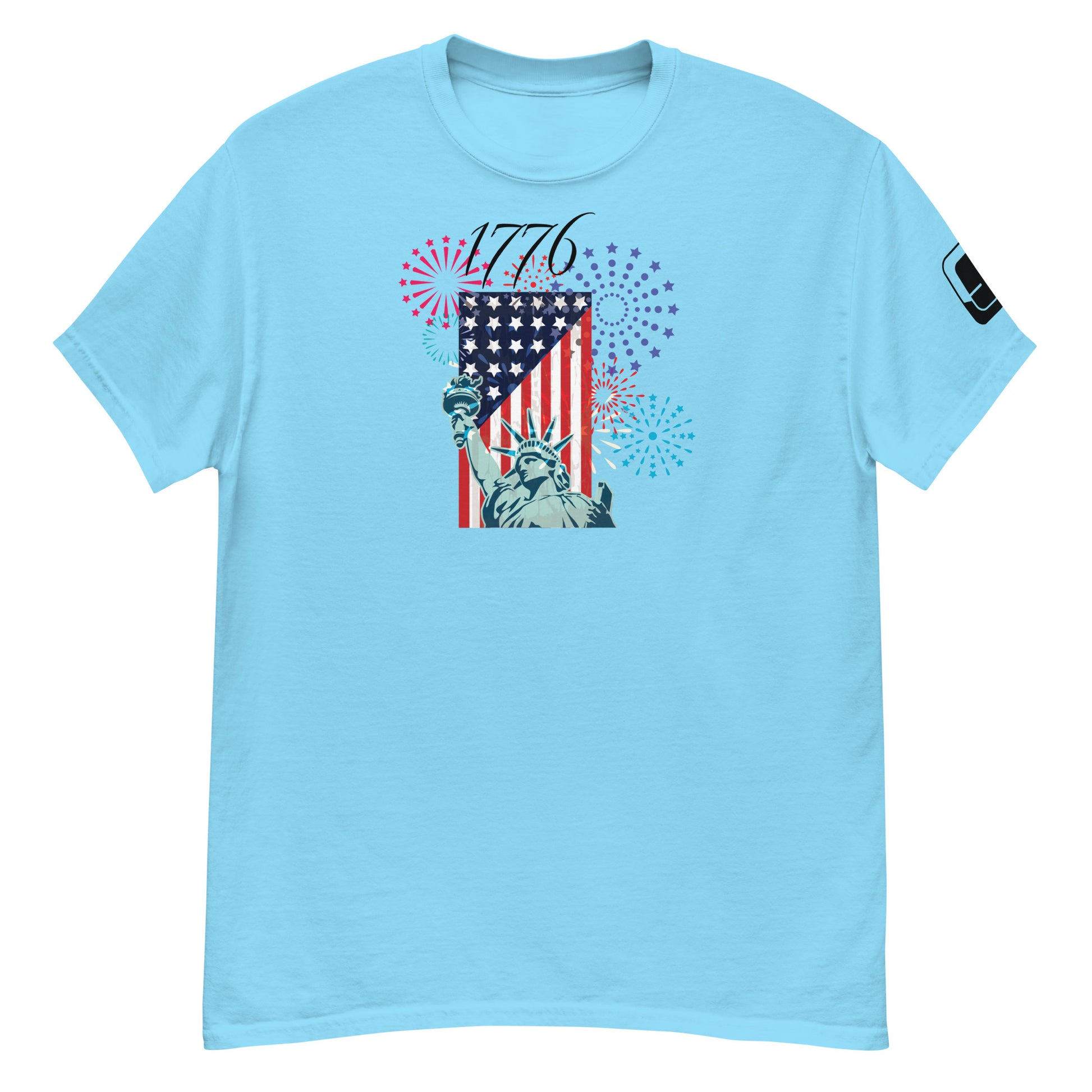 A sky blue t-shirt displaying a vibrant and patriotic design featuring the Statue of Liberty and a diagonally placed American flag. The shirt is adorned with colorful fireworks graphics in red, blue, and purple, symbolizing celebration. The year '1776' is prominently shown in a bold font, encapsulating the spirit of American independence.