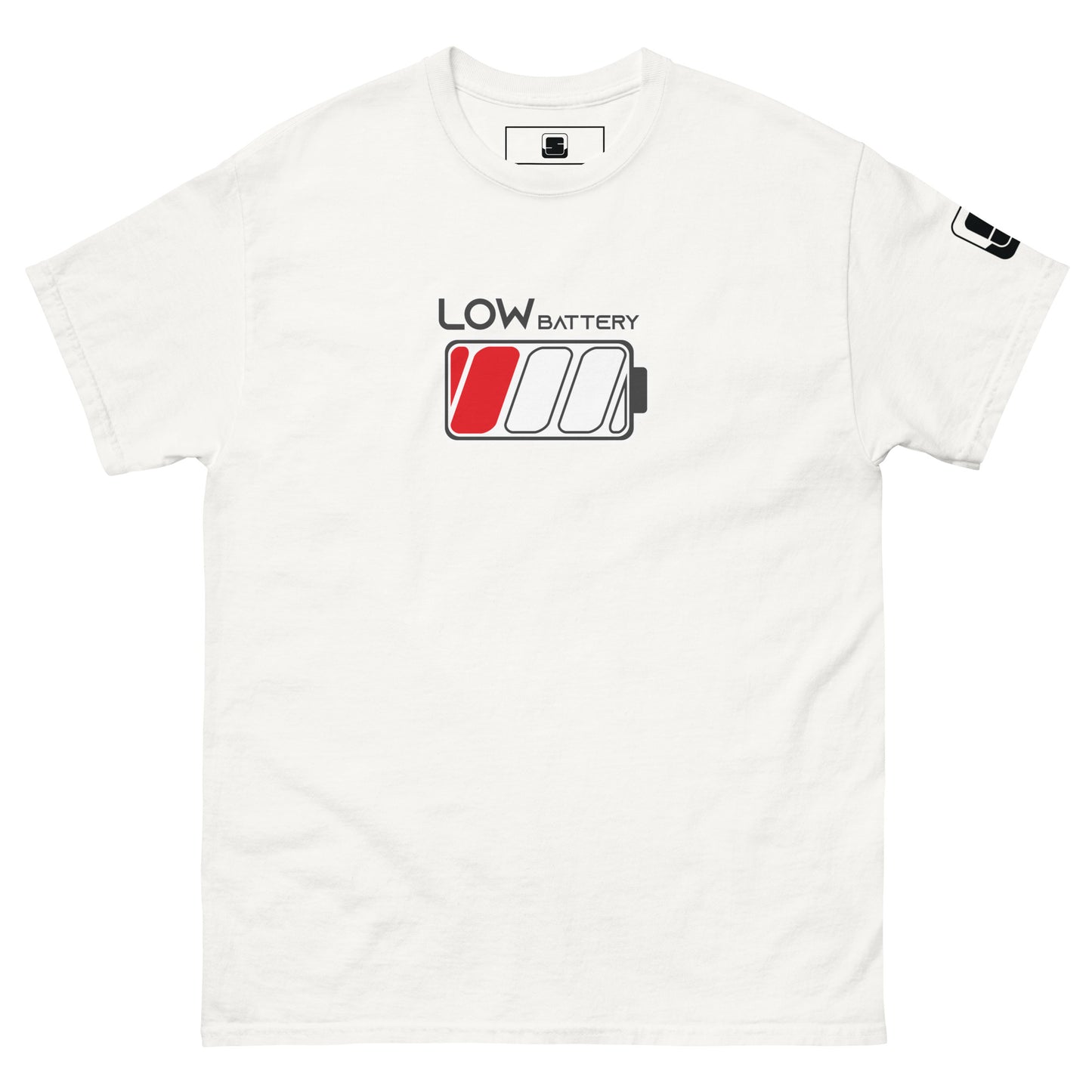 A white t-shirt features the design "LOW BATTERY" in grey lettering outlined in white, located near the chest area. The design includes a stylized battery icon with three cells; the leftmost cell is filled in red, indicating a low charge. The shirt has a relaxed fit with a ribbed round neck and short sleeves marked by a black logo tag on the right sleeve.