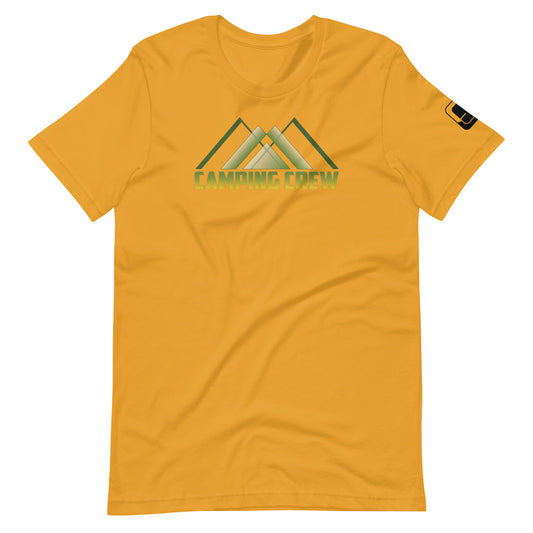 A vibrant golden yellow t-shirt featuring a captivating outdoor-themed graphic. The design displays the text 'CAMPING CREW' in reflective green with a chrome-like finish. Above the text, an artistic depiction of three overlapping green mountain peaks accentuates the spirit of adventure. The mountains are highlighted with subtle shades of green and white, symbolizing the serene beauty of nature, perfect for any camping aficionado.
