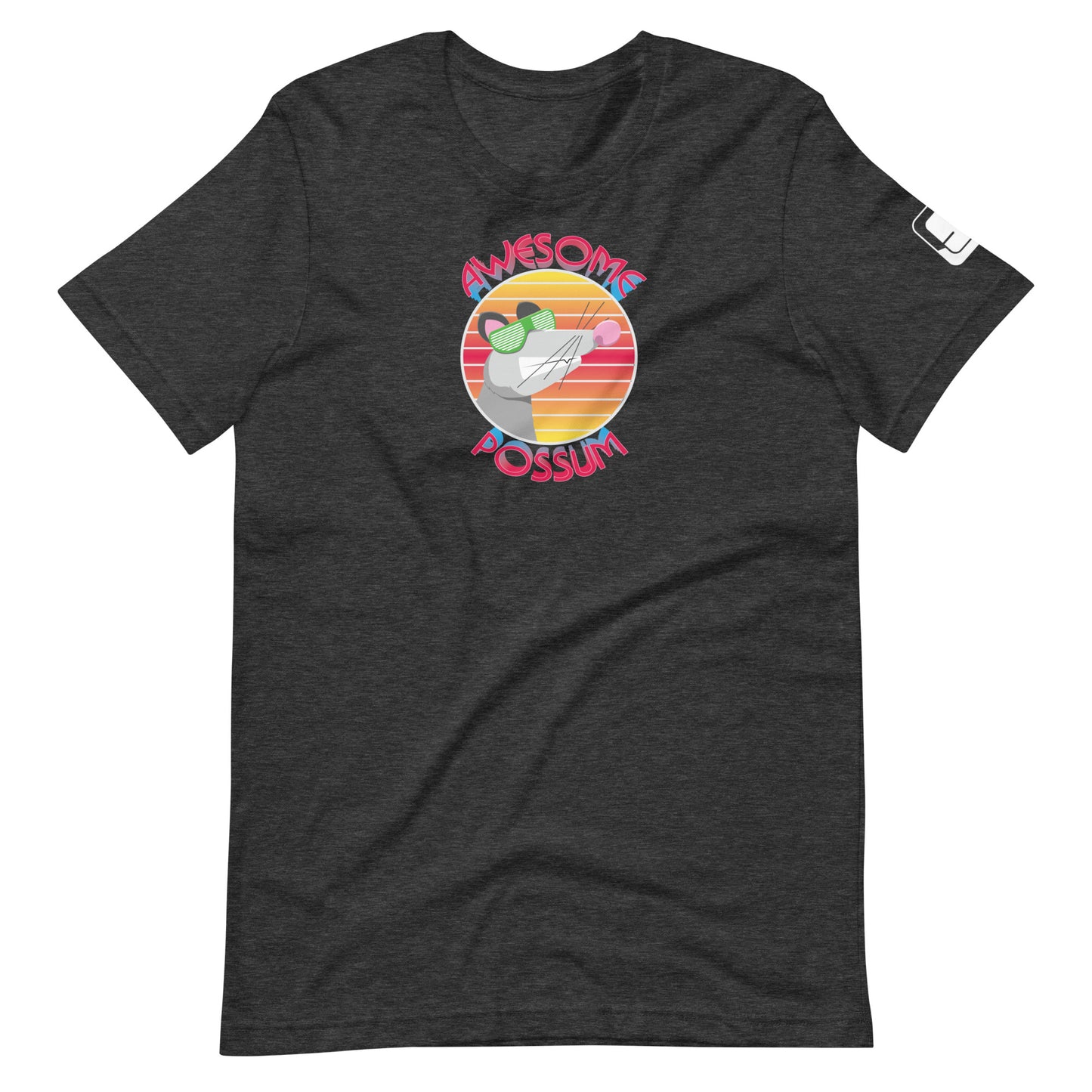 A charcoal gray t-shirt showcases a colorful circular design with the text "AWESOME POSSUM" surrounding an illustration of a possum wearing stylish green sunglasses. The possum is set against a background of warm, sunset-like stripes that enhance the playfulness of the design. The t-shirt features a relaxed fit with a crew neck and short sleeves, ideal for a casual, fun look.