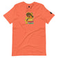 An orange t-shirt displayed flat, featuring a vibrant "Taco Tuesday" graphic. The graphic shows a cheerful fish, tucked inside a taco and wearing a multicolored sombrero, giving a thumbs up. The illustration is playful, with the text "Taco Tuesday" in a fun, colorful font below the image, set against the taco shell. The design is whimsical and festive, ideal for casual outings or themed events.