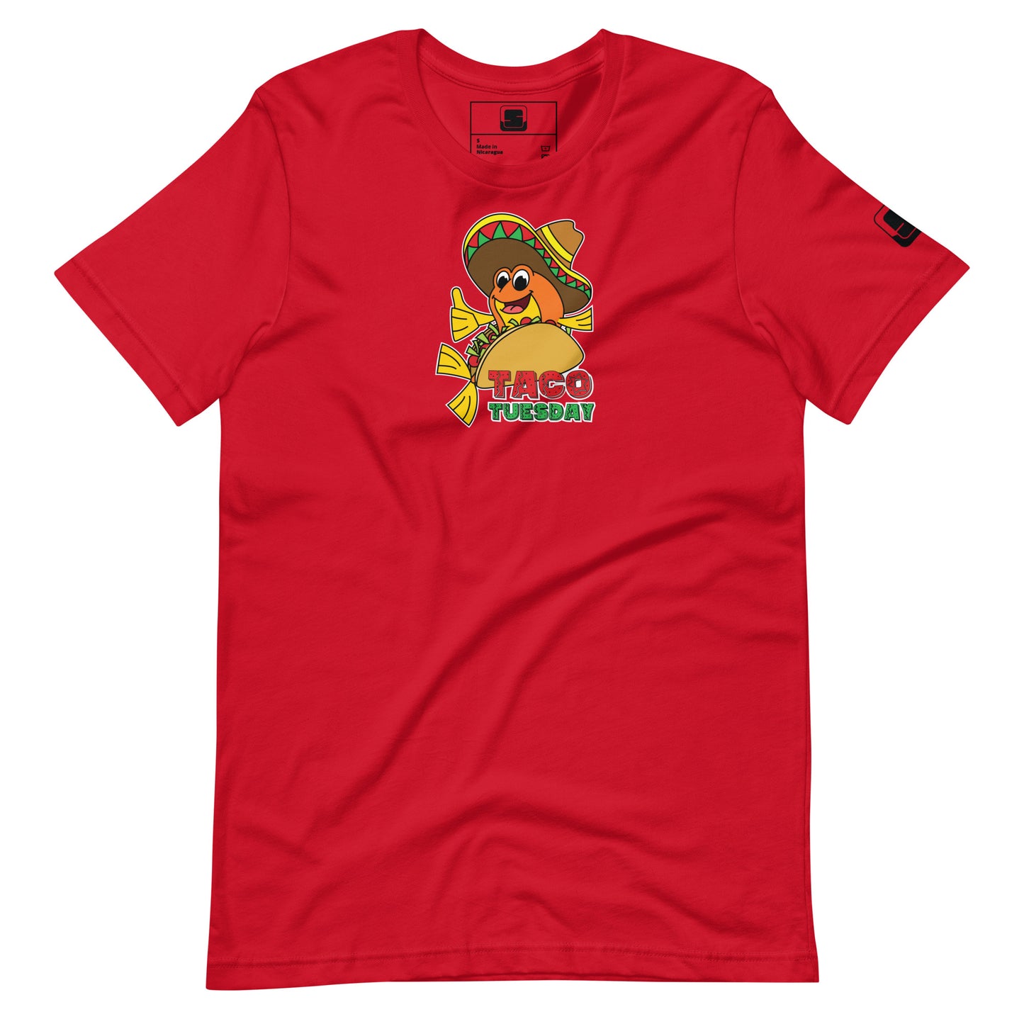 A vibrant red t-shirt laid flat, adorned with a "Taco Tuesday" graphic prominently placed on the front. The graphic features a gleeful fish wearing a multicolored sombrero, nestled inside a taco, and giving a thumbs up. The illustration combines playful and festive elements, with the phrase "Taco Tuesday" in a lively, colorful font set below the image, highlighting the casual and fun theme of the shirt.