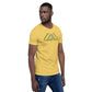 A thoughtful Black man stands in profile, wearing a mustard yellow t-shirt emblazoned with the 'CAMPING CREW' logo in green. The design features an abstract mountain motif above the text, embodying a love for outdoor adventures. He pairs his tee with casual denim jeans, looking off to the side against a neutral background.