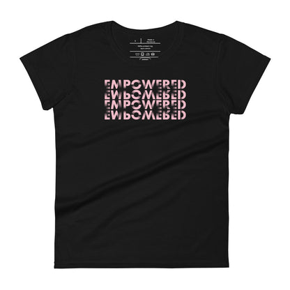 A black t-shirt showcasing a creative typographic design of the word "EMPOWERED" repeated four times to form a three-dimensional cube illusion. The text is in a bold, pink font that provides a vibrant contrast against the black fabric, emphasizing the empowering message with an eye-catching visual effect.